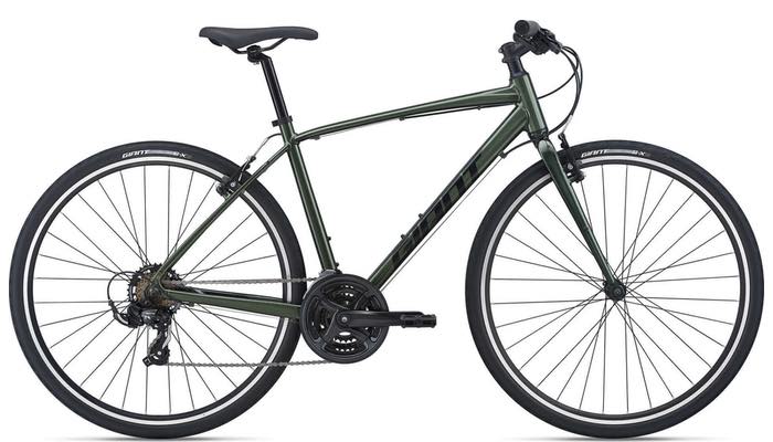 This image showcases an adult green hybrid bike from Hanging Lake Adventure Co-op and Glenwood Canyon Bikes.