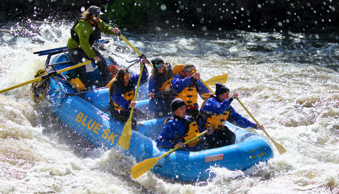 An image capturing the adventure of a Blue Sky-branded raft navigating the Shoshone Rapids on the Colorado River.