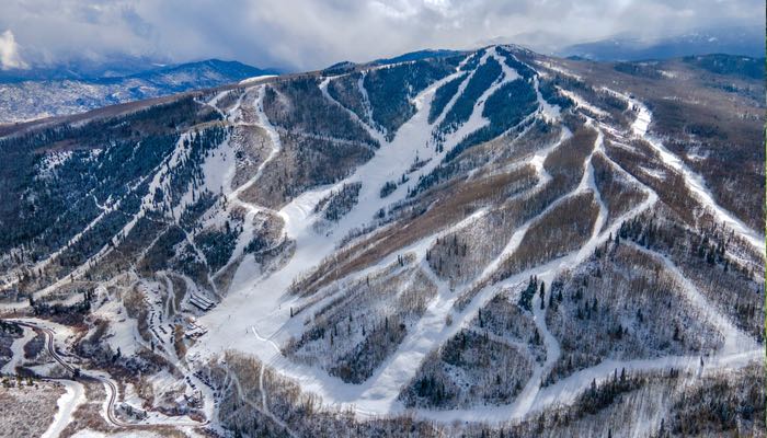 Captured from above, this photo offers an aerial view of Sunlight Mountain Resort, revealing a network of ski runs intricately winding through the mountainous terrain.