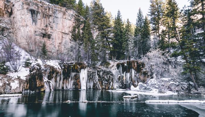 In this photograph, the tranquil allure of Hanging Lake in Glenwood Springs, Colorado is frozen in winter's embrace.