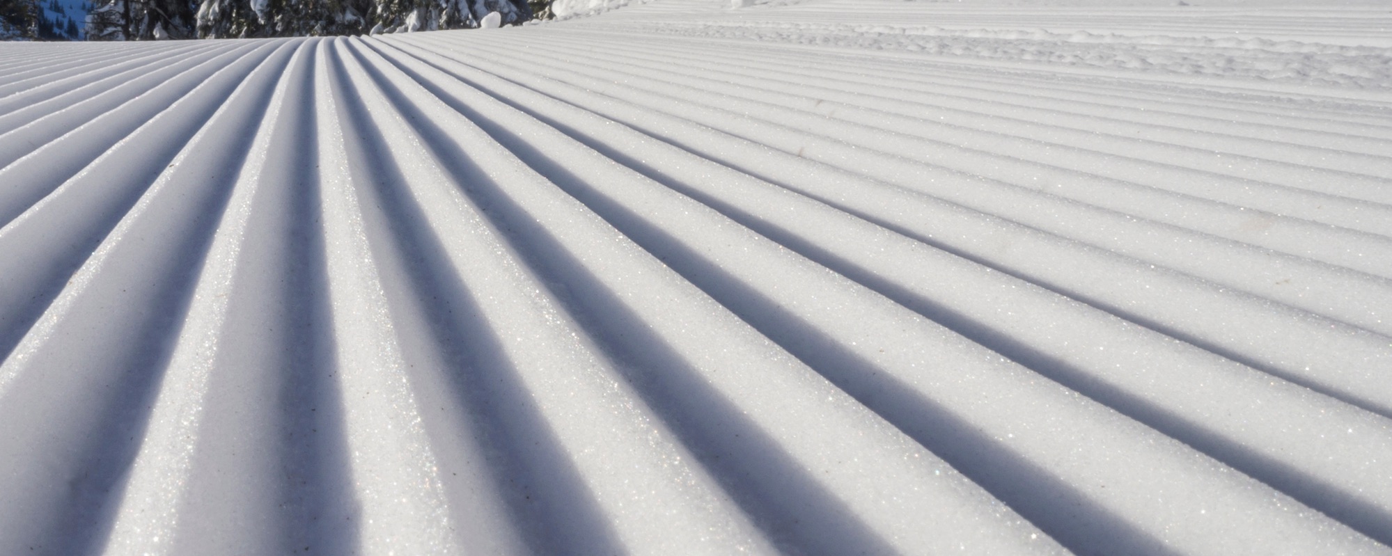 Experience the pristine beauty of freshly groomed snow in this captivating up-close image.