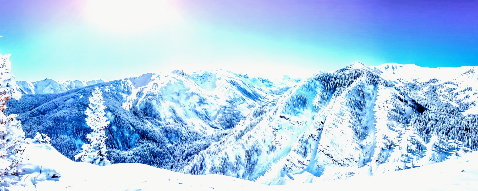 An image of snow-covered mountains with a high contrast, creating an almost artistic, drawing-like appearance.
