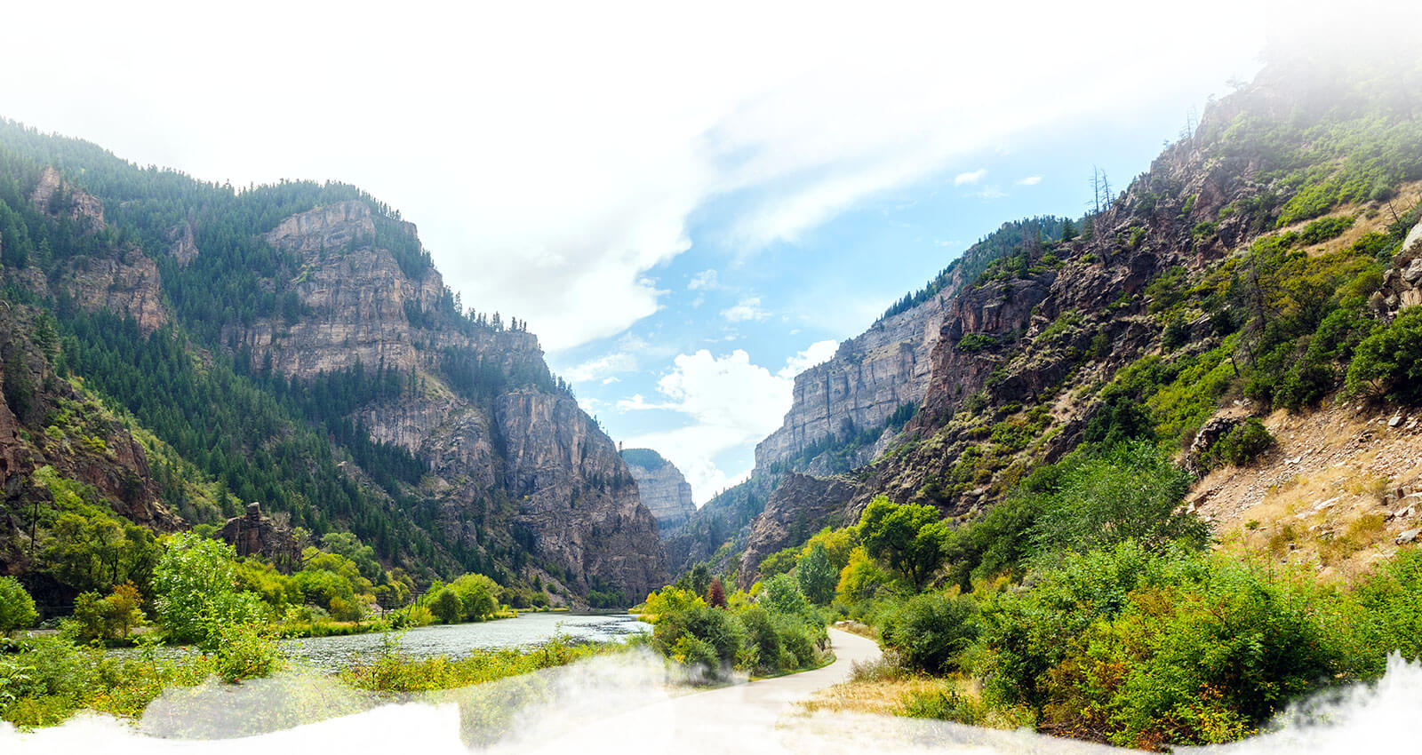 Image of the Colorado River and Glenwood Canyon Bike Trail near the Hanging Lake Trailhead in the Glenwood Canyon. The river, vegetation and canyon walls make a stunning view from the trail.
